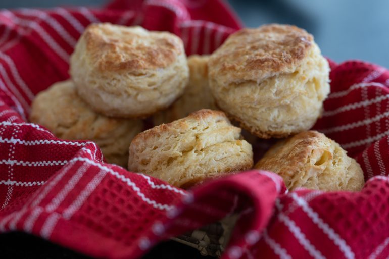 A basket of golden brown southern buttermilk biscuits.