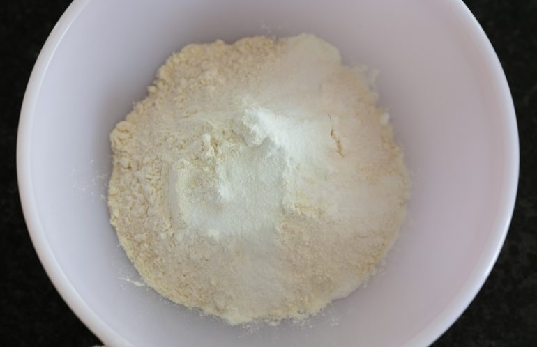 Flour and other ingredients in a pink bowl.