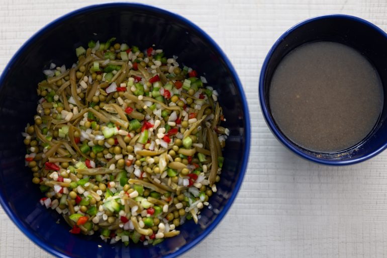 Photo of vegetables in a bowl chopped and ready with what looks like marinade in another bowl.