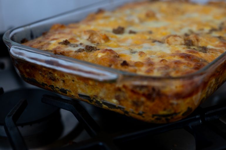 A close up photo of a casserole that has been cooked. It looks cheesy and delicious.