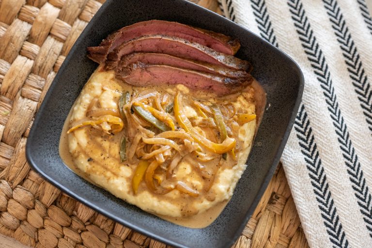 Creole Flank Steak Over Cheddar Grits with Creamy Pan Sauce